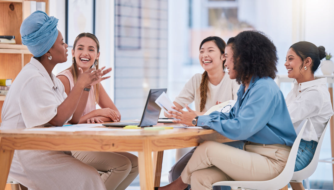 a group of women laughing at a table