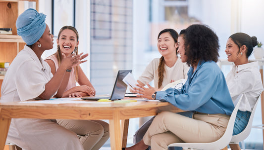 a group of women laughing at a table