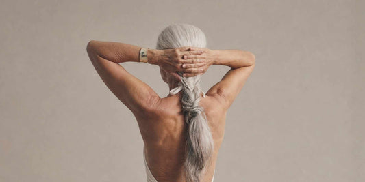 A woman with her hands crossed behind her head