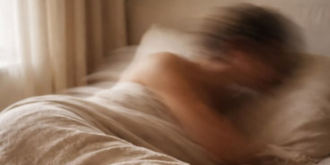 A blurred woman lying in bed
