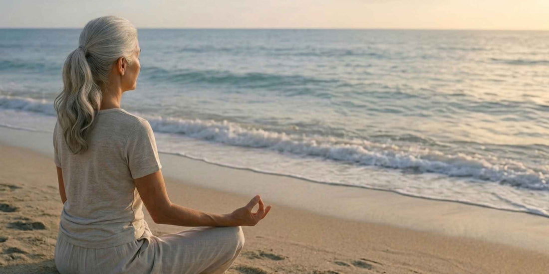 A woman meditating on the beach