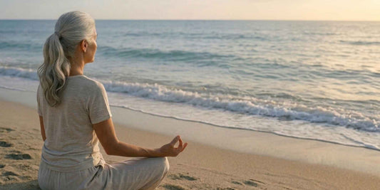 A woman meditating on the beach